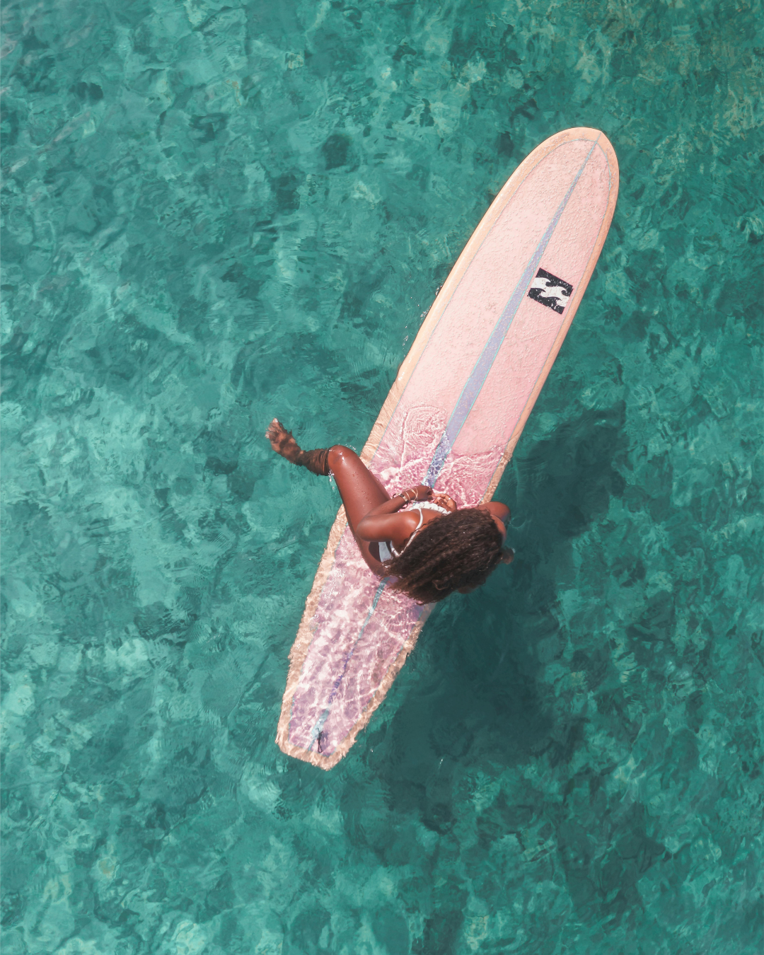 black woman surfing in the beach